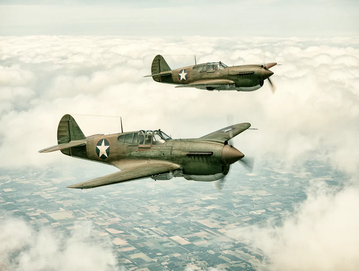 A silver warbird banking overhead